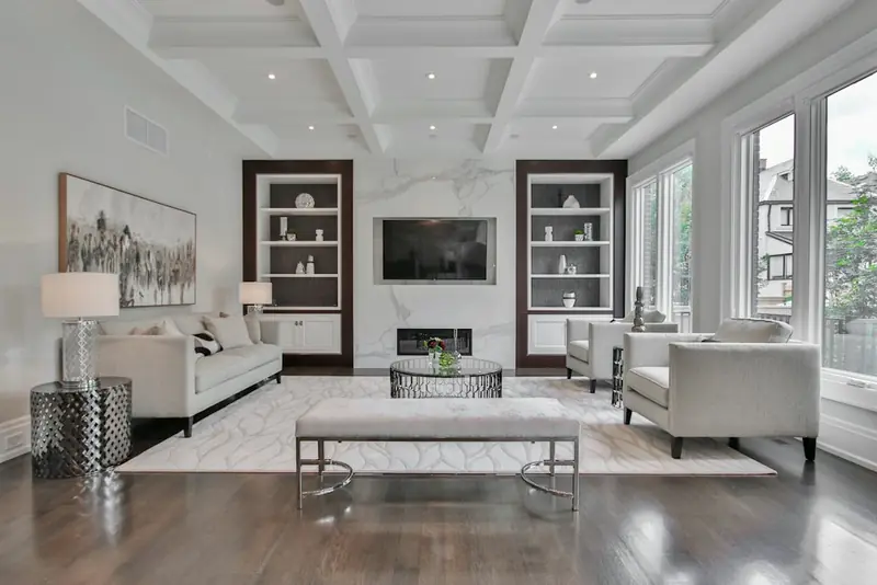 Illustrative bright living room with pale sofas and a fireplace